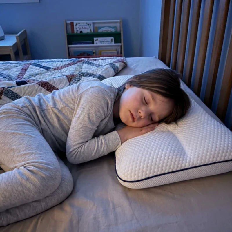 Kind slaapt op de zij op het kinderkussen